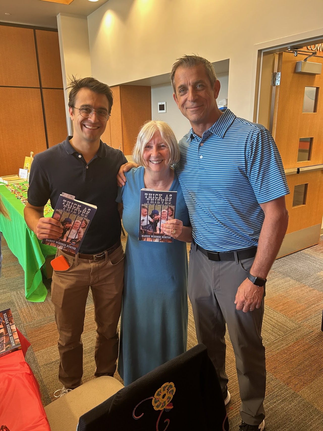 Margie, center, with friends at the book launch