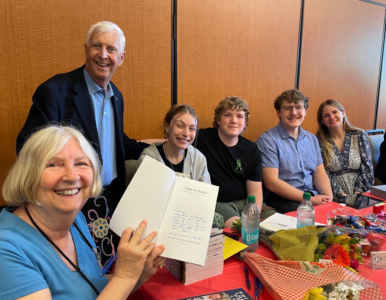 Margie celebrating a signed book with her family