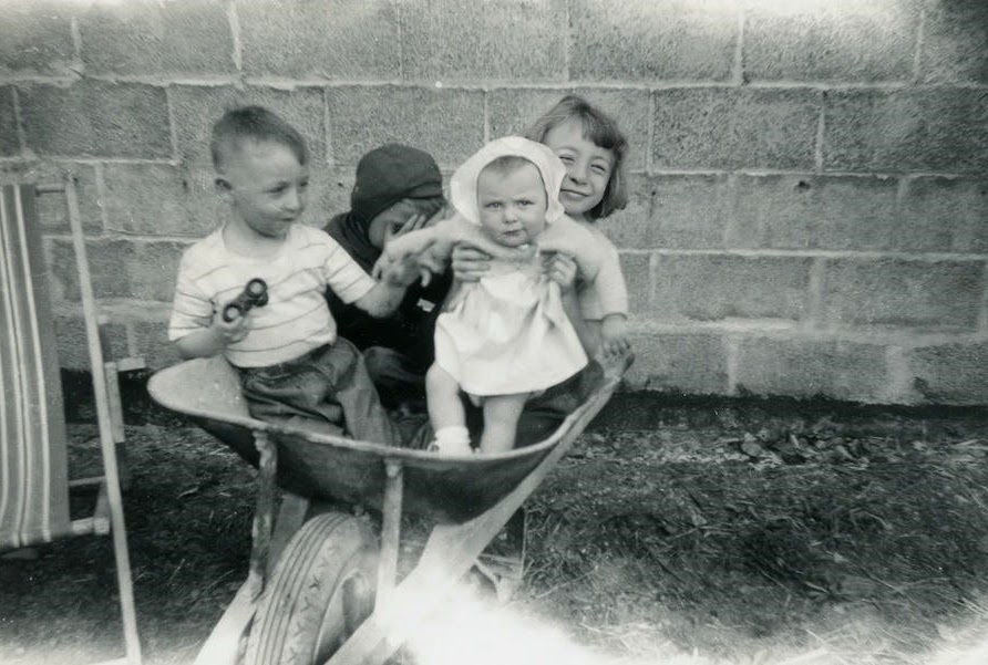 Pauly, Bobby, Margie and Lainie in a wheelbarrow